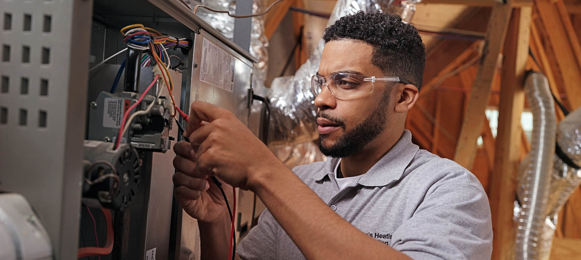 Technician performing furnace repairs
