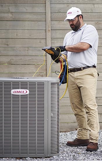 A man inspects an AC unit