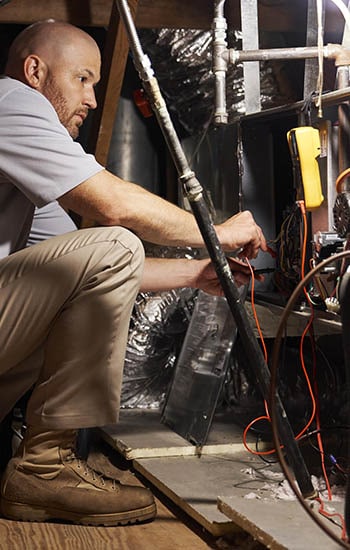 A Man Repairs a Furnace